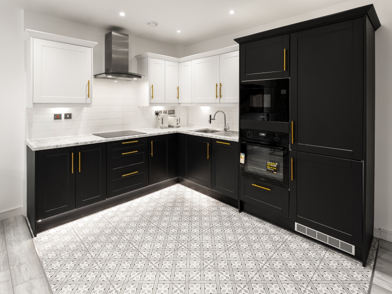Modern Kitchen With Sleek Black Lower Cabinets, White Upper Cabinets, And A Decorative Grey And White Patterned Tile Floor.